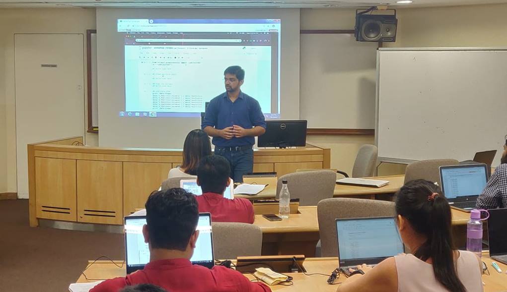 Shivam (centre), conducting a workshop on Python for data processing to fellow students as part of the Business Analytics Club