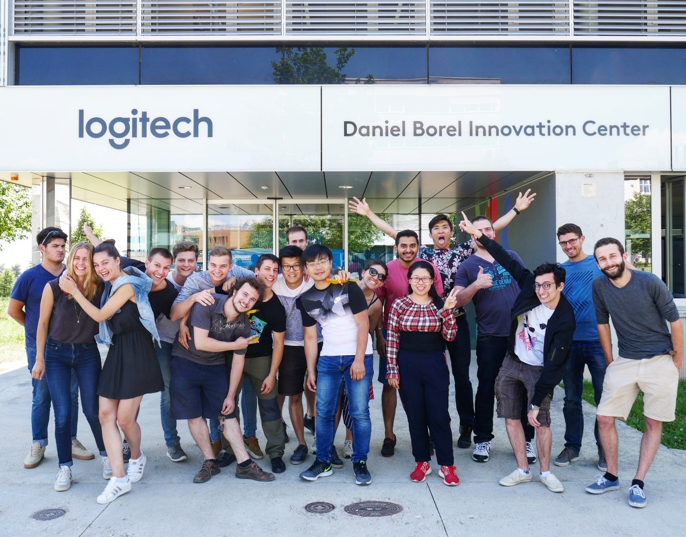 Vincent (last row, arms raised) with his colleagues at Logitech